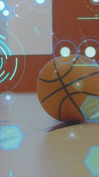 Vertical video: Cam panning revealing stationary basketball under AR hexagon radar for sports tech
