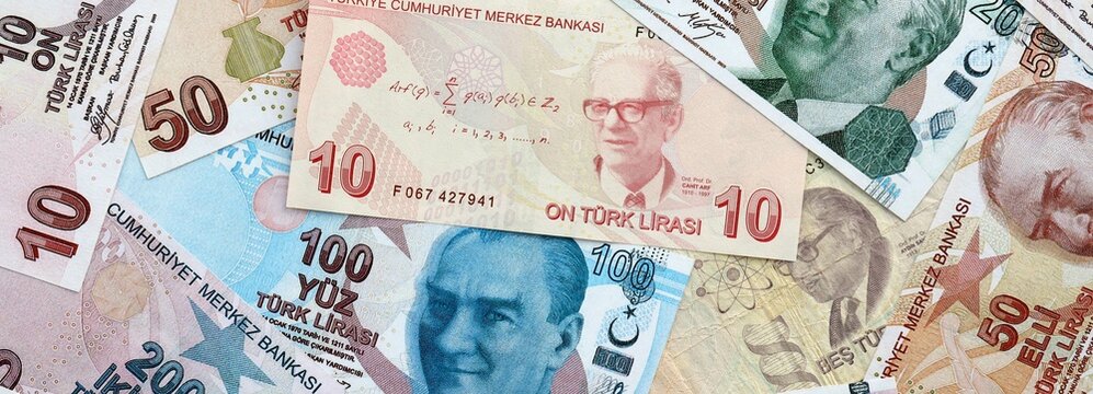 Turkish lira money banknotes pile on table. Turkey bills of TRY currency. Concept of economy