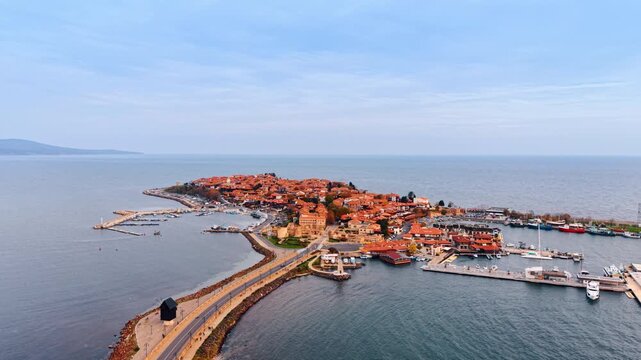 The isthmus with road leading to the peninsula with old town. The Pearl of the Black Sea, Nesebar, Bulgaria. Aerial view.