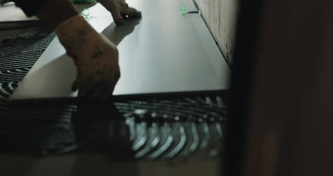 Laying floor tile with spacers during installation process close up