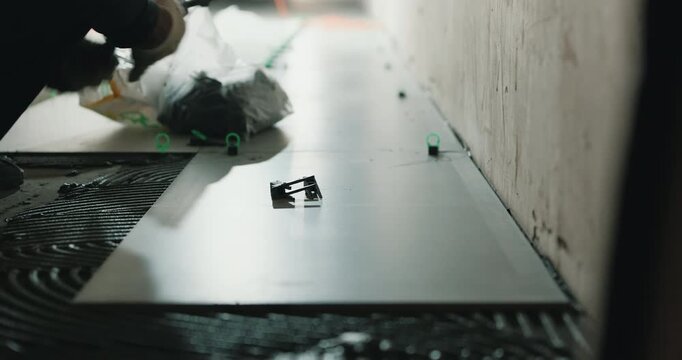 Leveling floor tile with spacers during installation process close up