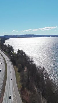 Vertical Aerial view of E4 highway running along V&auml;ttern lake in J&ouml;nk&ouml;ping, Sweden