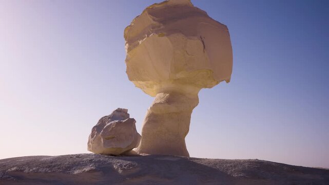 Smooth approach to mushroom-shaped limestone formation in Egypt&rsquo;s White Desert at sunrise. Smooth camera movement approaching a famous mushroom-shaped limestone formation in Egypt&rsquo;s White Desert.