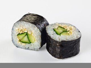 Two cucumber and sesame maki sushi rolls isolated on white background © Andrei Starostin