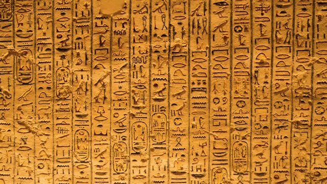 Ancient Egyptian hieroglyphs on tomb walls, Valley of the Kings, Luxor. Close-up of colorful Egyptian hieroglyphs and symbols on interior tomb walls in the Valley of the Kings. 