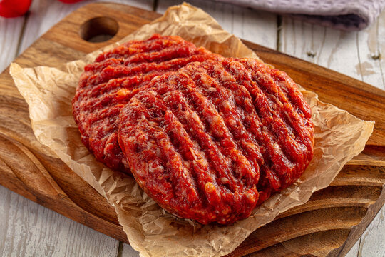 Raw uncoocked red beef round cutlet