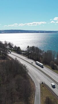 Vertical Aerial view of E4 highway running along V&auml;ttern lake in J&ouml;nk&ouml;ping, Sweden