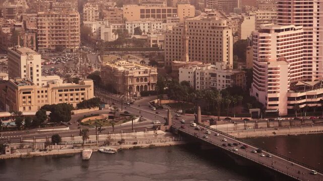 Kasr El-Nil Bridge over the Nile River in Cairo, Egypt. Aerial vertical shot of Kasr El-Nil Bridge over the Nile River in Cairo, Egypt, showing cars crossing the bridge and the bustling city