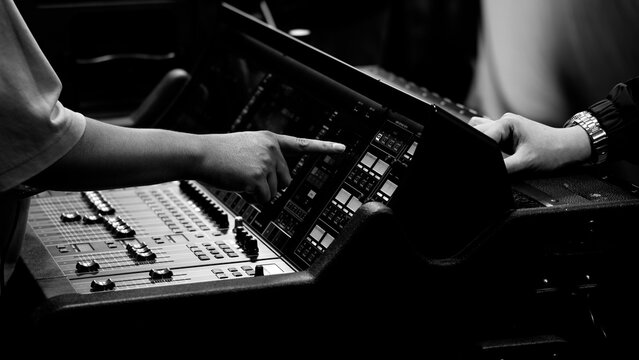 Mixing operation. Professional audio or sound engineers operating digital mixing consoles in studio or live mix perform. Sound control music production broadcasting mix and live event audio technology