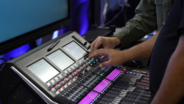Mixing operation. Professional audio or sound engineers operating digital mixing consoles in studio or live mix perform. Sound control music production broadcasting mix and live event audio technology