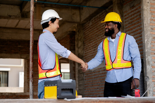 Engineer and construction worker discussing building plan at site, pointing direction with clipboard, teamwork, safety gear, construction planning concept. engineer, worker, construction, site
