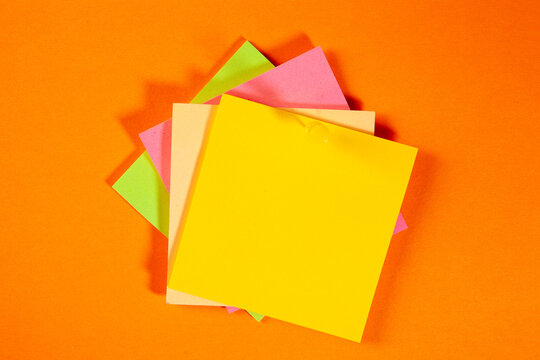 colorful paper notes on a yellow background. flat lay top view.