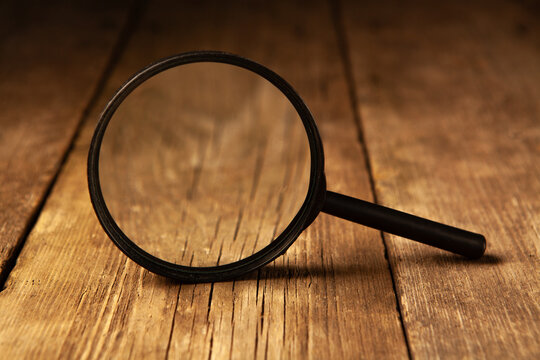 Magnifying glass on wooden background. Zoom tool. Zoom tool.