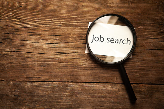 find job word on a wooden block with a magnifying glass. business concept.