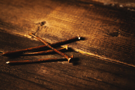 Old rusty nails on wooden background. Selective focus. Shallow depth of field. Toned.