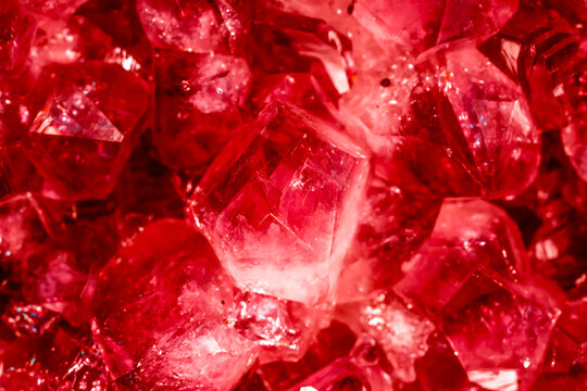 Amethyst red crystals. Gems. Mineral crystals in the natural environment. Texture of precious and semiprecious stones. Seamless background with copy space colored shiny surface of precious stones.