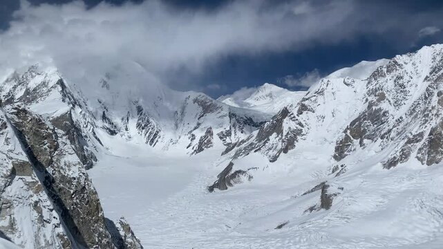 Snow covered mountains captured at 20000 feet with crevasses and moraines below