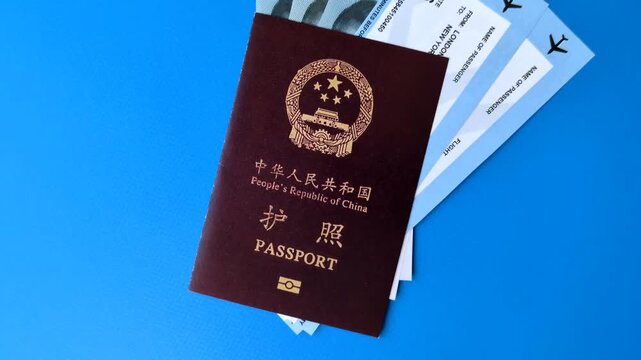 China, Chinese passport with money and flight tickets. Chinese passport with tickets as a background for your design