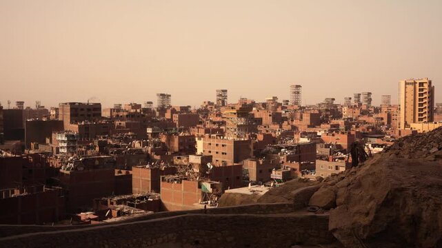 Elevated view of Cairo Garbage City with dense brick buildings and rooftop structures. Elevated view over Cairo&rsquo;s Garbage City showing dense rows of similar brick residential buildings.