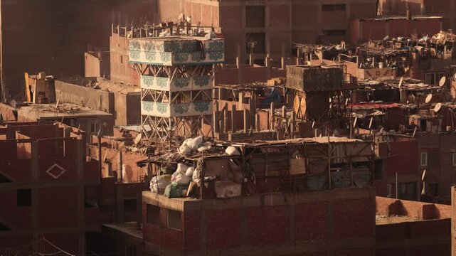 Close-up of rooftops with stacked waste bags in Cairo Garbage City. Close-up view of several brick buildings in Cairo&rsquo;s Garbage City. The rooftops show densely stacked bags of waste