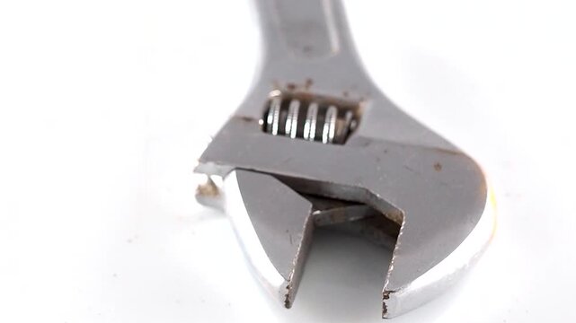 Adjustable wrench opening and closing isolated on white background