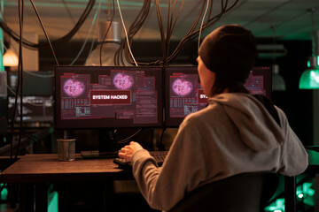 Encryption specialist looking at alert message to hack system, trying to break into computer server and database. Male thief planting trojan virus to create malware, hacking network. © DC Studio