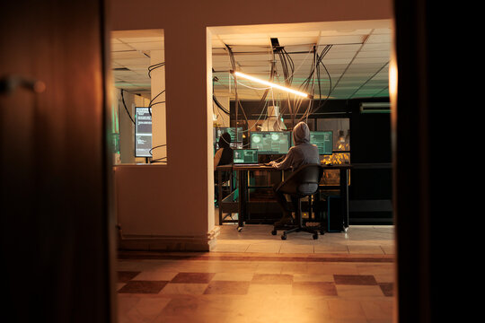 Young adult planning phishing attack with trojan virus, causing computer malware to access professional database. Female hacker cracking encryption code to hack network system.