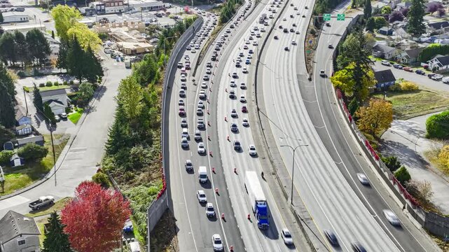 Aerial timelapse of highway traffic merging through a road construction zone on a busy city interstate