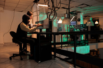 Team of cybercriminals fixing computer system cyberattack, using trojan virus to hack server. Diverse thieves programming app, cybersecurity technology, database spyware protection. © DC Studio