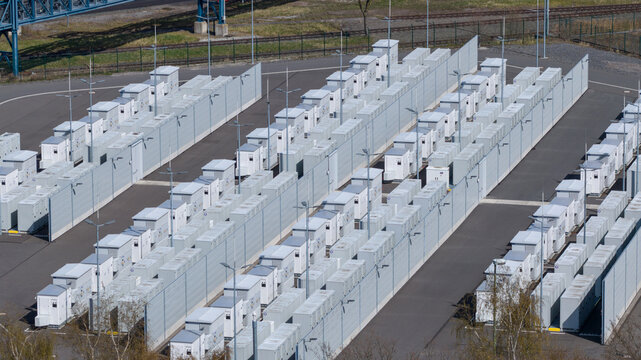 Hamm, Germany - 06 April 2026: Aerial view of the battery storage facility at the RWE Westfalen power plant with rows of white units and grey partition walls.