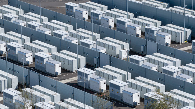 Hamm, Germany - 6 April 2026: Aerial view of the RWE Westfalen power plant battery storage facility with rows of white containers and grey partition walls.
