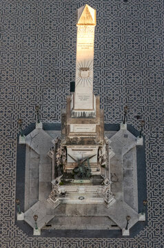 Lisboa, Portugal - 04 April 2026: Aerial view of the Monument to the Restorers obelisk centered on the intricate geometric patterns of the Portuguese pavement in Restauradores Square.