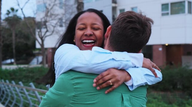 Slow motion video of a couple reunites with passion as the woman runs to her partner and jumps into his arms, sharing an emotional hug that reflects love, intimacy, and romantic connection.