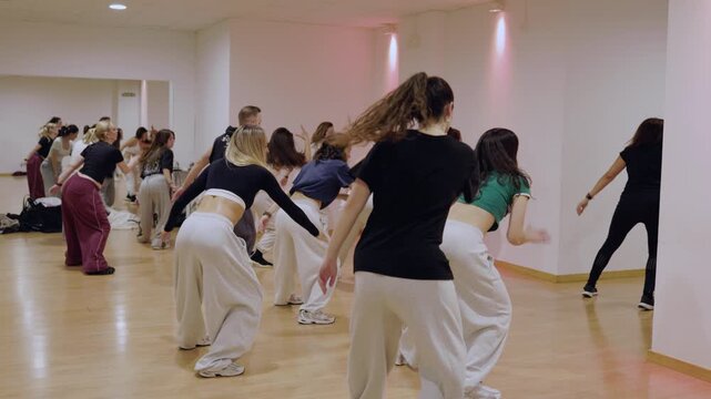 Group of dancers learning new choreography in studio