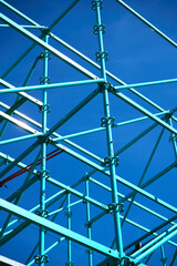 Fototapeta premium Geometric steel structure with clean blue background