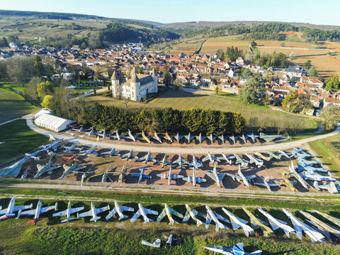 Savigny-les-Beaune, France - 05 April 2026: Aerial view of the Chateau de Savigny-les-Beaune featuring its extensive collection of vintage fighter jets parked in rows near the historic castle.