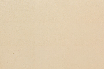 Obraz premium Finely textured beige paper surface exhibits subtle variations and visible fibers throughout its expanse.