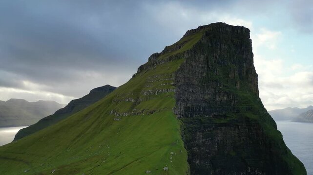 Cinematic 4K aerial drone shot soaring over the rugged cliffs of Kalsoy Island in the Faroe Islands.