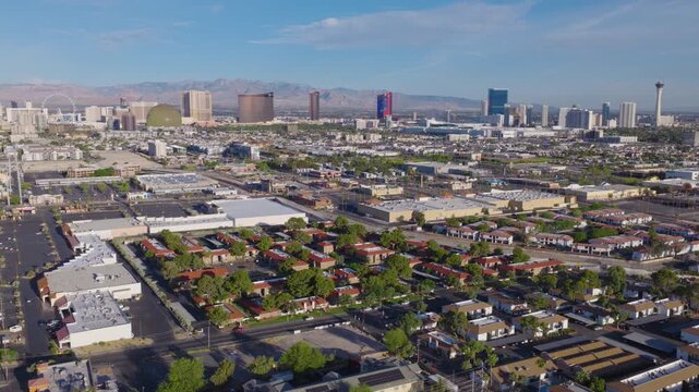 Aerial Drone Las Vegas suburbs with Strip skyline and desert mountains