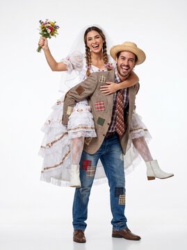 Happy Brazilian festa junina couple in wedding attire, smiling and celebrating isolated on white background. Traditional caipira style, love, joy, culture, studio shot.