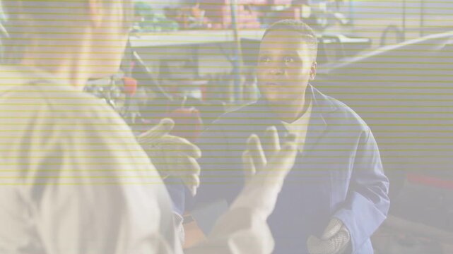 Tech offering part auto shop blue peer reaching and inspecting for repair as scan-lines overlaying
