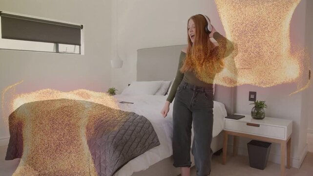 Woman dancing by bed, headphones appearing, initiating golden particles while listening to music
