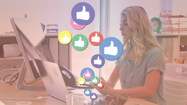 Office worker typing while receiving rising like icons passing over face, reacting for social media
