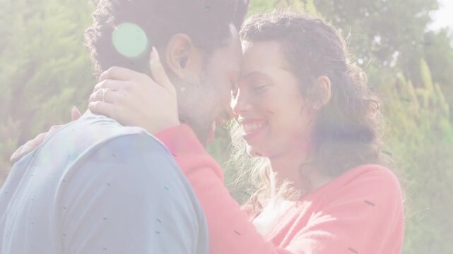 Couple in park, woman placing hands on man's neck, touching heads showing love overlay crossing ad