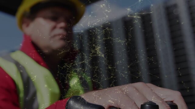 Male operator pressing joystick, moving crane guiding lift, camera receding, scratch over hardhat