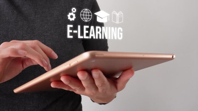 Close-up of a businesswoman interacting with her tablet with an animation of the word "e-learning" featuring icons of a globe, gears, a graduation cap, and a book. Online education.