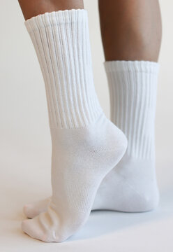 Female Legs Wearing White Ribbed Crew Socks Side View Minimal Studio Shot