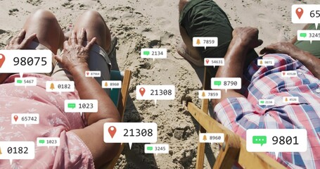 Fototapeta premium Relaxing couple in plaid and pink dress reclining on sand in wooden chairs with AR overlays
