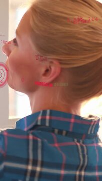 Vertical video: Woman turning to window causing HUD rings over face then back while tracking crypto