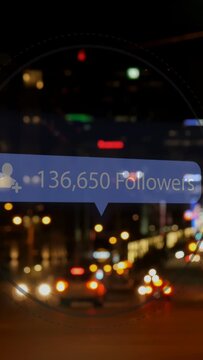 Vertical video: Car lights causing blue follower bubble updating count, showing growth over blur